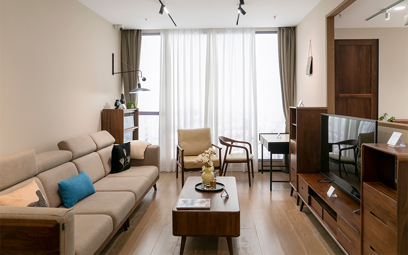Compact living room with beige sofa.