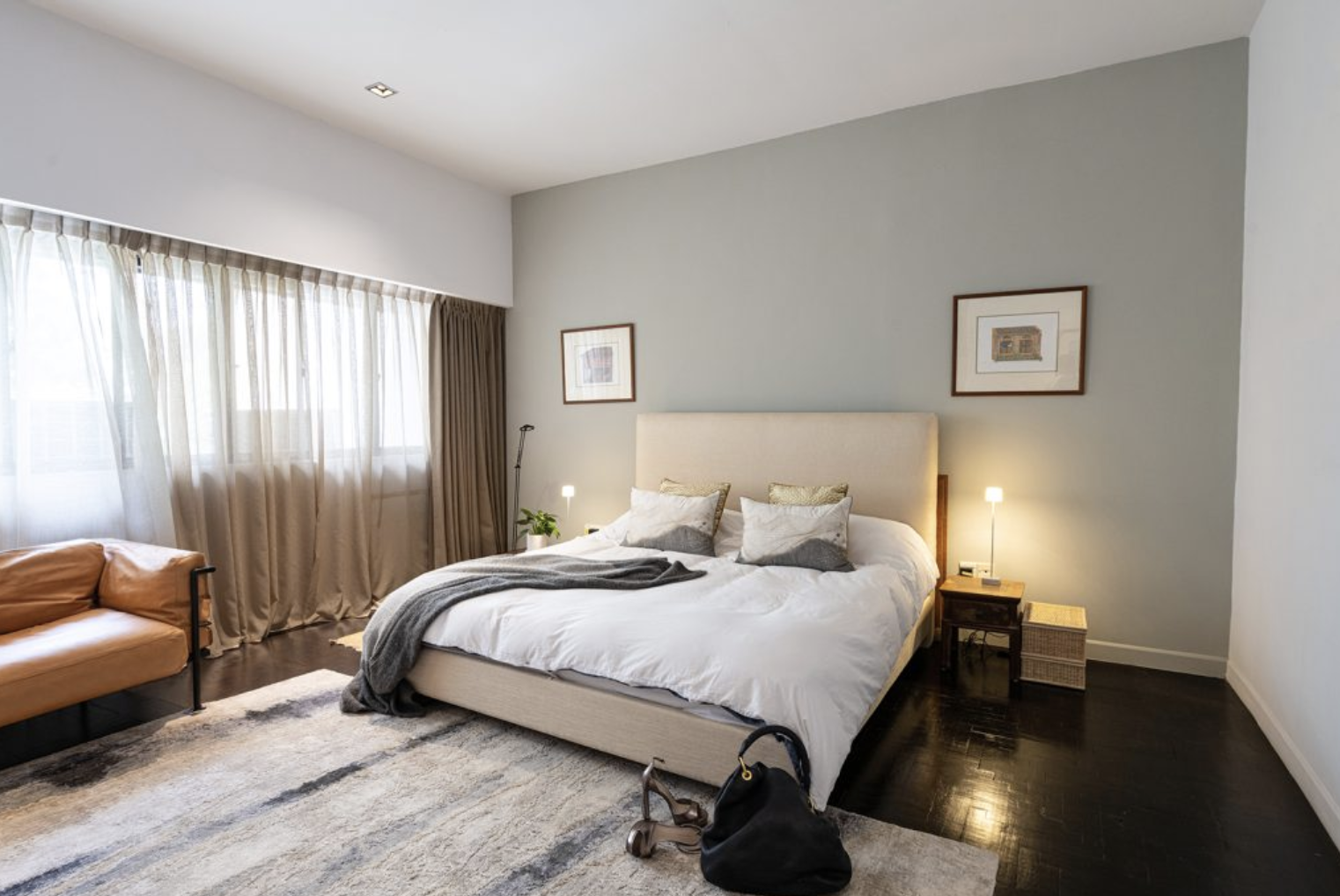 Stylish beige upholstered bed setup in modern Singapore home bedroom.